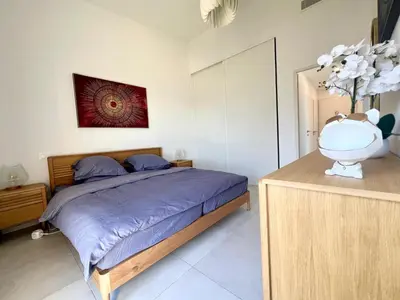 a bedroom with a bed and a vase of flowers at Panoramic Sea View Appartment Blue Pearl in Nice