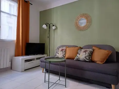 a living room with a couch and a table at Appartement Nice Libération in Nice