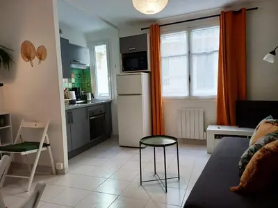 a kitchen and living room with a refrigerator and a table at Appartement Nice Libération in Nice