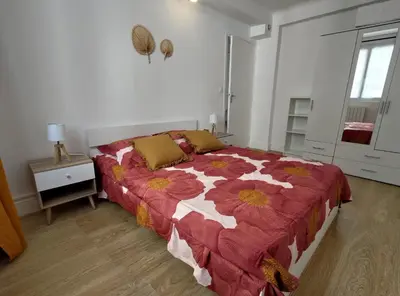 a bedroom with a large bed with a flower comforter at Appartement Nice Libération in Nice