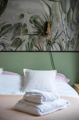 a bedroom with a bed with a painting on the wall at Pink Palace - Quartier Authentique Libération in Nice