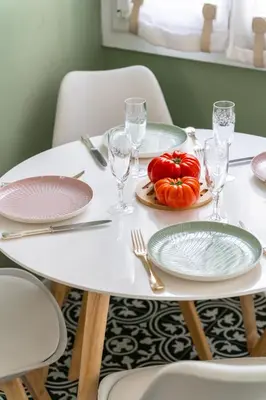 a white table with plates and glasses and pumpkins on it at Pink Palace - Quartier Authentique Libération in Nice