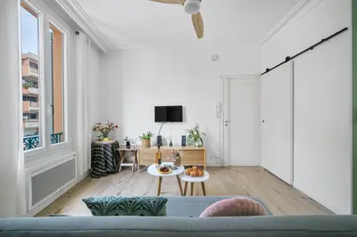 a living room with a couch and a table at Pink Palace - Quartier Authentique Libération in Nice