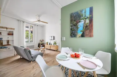 a dining room with a white table and chairs at Pink Palace - Quartier Authentique Libération in Nice