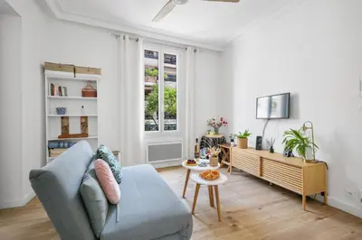 a living room with a blue couch and a table at Pink Palace - Quartier Authentique Libération in Nice