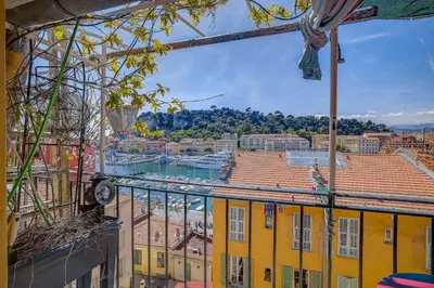 a view of a city from a yellow building at Dernier étage port de Nice in Nice