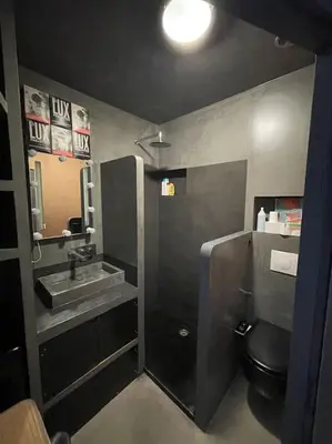a bathroom with a sink and a toilet and a mirror at Dernier étage port de Nice in Nice