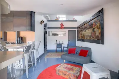 a living room and kitchen with a chair and a table at Dernier étage port de Nice in Nice