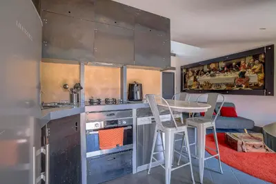 a kitchen with a table and chairs in a room at Dernier étage port de Nice in Nice