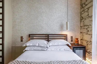 a bedroom with a bed with white pillows at Naomi Nice in Nice