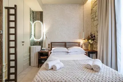 a bedroom with a bed with towels on it at Naomi Nice in Nice
