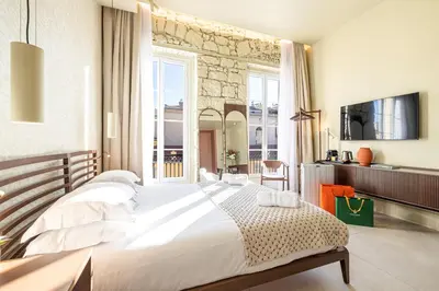 a bedroom with a large bed and a large window at Naomi Nice in Nice