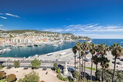 a view of a harbor with palm trees and the water at FEEL HOME - VISTA Di PORTU in Nice