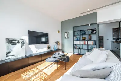 a living room with a couch and a tv at FEEL HOME - VISTA Di PORTU in Nice