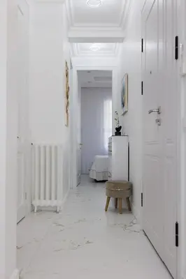 a hallway with white walls and a room with a door at Appartement 3 PIECES NICE Promenade in Nice