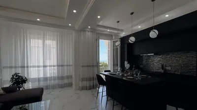 a living room with a dining table and a fireplace at Appartement 3 PIECES NICE Promenade in Nice