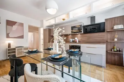 a kitchen and dining room with a glass table and chairs at Luxueux, spacieux et tout équipé à 5 min du port in Nice