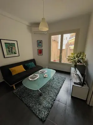 a living room with a glass table and a couch at Perfectly located holiday place in Beaulieu-sur-Mer