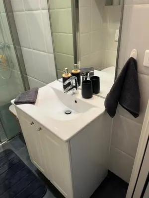 a bathroom with a white sink and a mirror at Perfectly located holiday place in Beaulieu-sur-Mer
