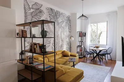 a living room with a yellow couch and a table at New Central Stylish 2 min from the beach Apartment in Nice