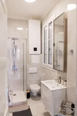 a white bathroom with a toilet and a shower at New Central Stylish 2 min from the beach Apartment in Nice