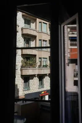a window view of a building with a balcony at New Central Stylish 2 min from the beach Apartment in Nice