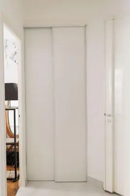a row of four white doors in a room at New Central Stylish 2 min from the beach Apartment in Nice