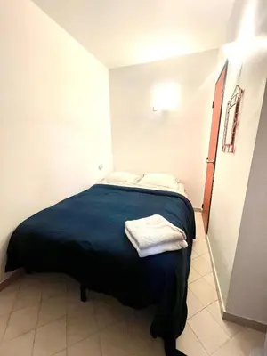 a bedroom with a bed with two towels on it at Apartment Massena - super central in Nice