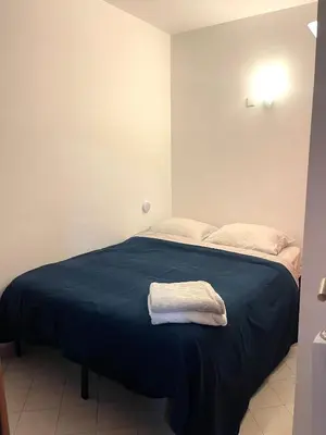 a bed with two white towels on top of it at Apartment Massena - super central in Nice