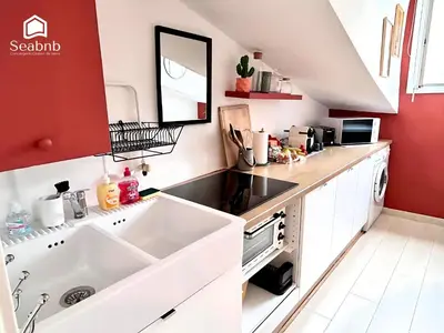 a kitchen with a white sink and a red wall at Little Nest - Old Town - Breakfast - Wifi - AC in Nice