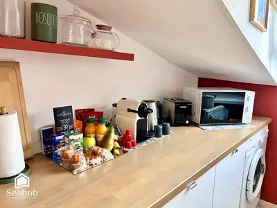 a kitchen counter with a microwave and some food on it at Little Nest - Old Town - Breakfast - Wifi - AC in Nice