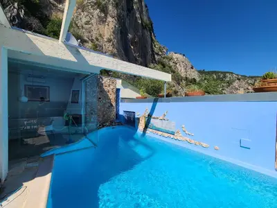a swimming pool in a house with blue water at Eze sur mer - vue Saint Jean Cap Ferrat in Èze