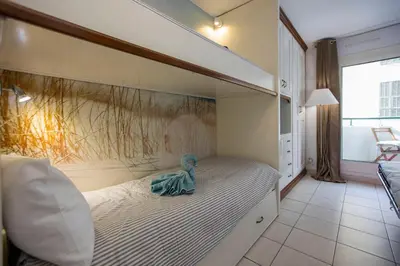 a doll sitting on a bed in a bedroom at Studio palais des arts in Nice