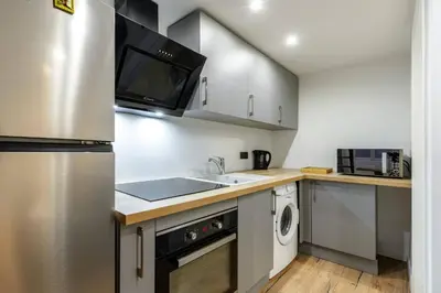 a kitchen with a sink and a microwave at Cocon au cœur du Vieux Nice in Nice