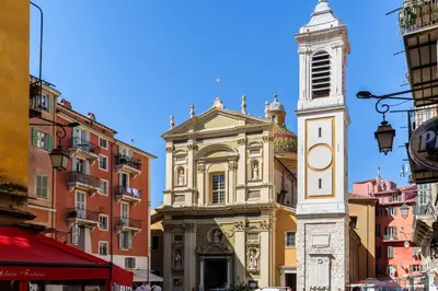 a building with a clock tower in a city at Cocon au cœur du Vieux Nice in Nice