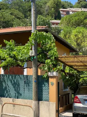 a pole in front of a house with a fence at Villa Serenice - F2 au calme, climatisé, WIFI et parking gratuit in Nice