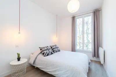 a white bedroom with a bed and a window at 253 MONT BORON - Appartement 2p - Balcon plein sud - Climatisation in Nice