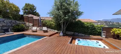 a backyard with a swimming pool and a wooden deck at VILLA MODERNE PISCINE JACUZZi in Nice