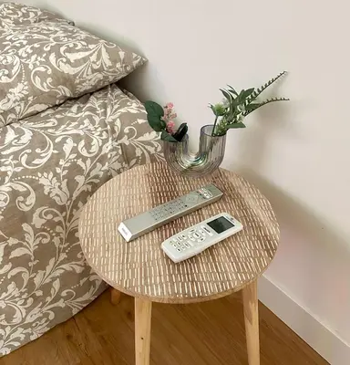 a table with a remote control and a vase on it at Studio Cosy à Nice Centre in Nice