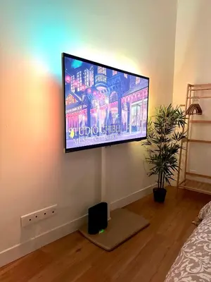 a flat screen tv on a wall in a room at Studio Cosy à Nice Centre in Nice