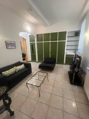 a living room with a couch and a coffee table at Centrale - Grand T2 Bis proche de la mer in Nice