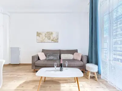 a living room with a couch and a table at CENTRE VILLE - SUPERBE APPARTEMENT CLIMATISE - COSY-Wifi - in Nice
