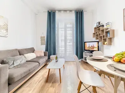 a living room with a couch and a table at CENTRE VILLE - SUPERBE APPARTEMENT CLIMATISE - COSY-Wifi - in Nice