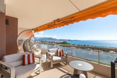 a balcony with chairs and a view of the ocean at Les Belles Terres - Résidence avec piscine vue mer in Nice