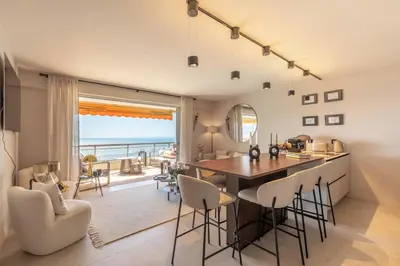 a kitchen and dining room with a view of the ocean at Les Belles Terres - Résidence avec piscine vue mer in Nice