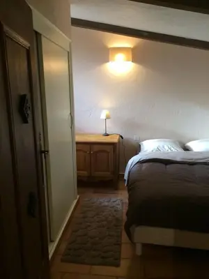 a bedroom with a bed and a table with a lamp at Maison de caractère in Saint-Jeannet