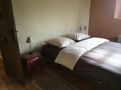 a bedroom with two beds and a table with a lamp at Maison de caractère in Saint-Jeannet