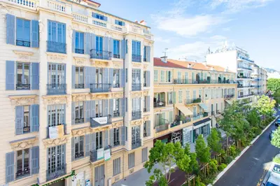 an apartment building with blue windows and a street at #13 Orange suite AC Wifi Balcony 3mins walk sea front in Nice