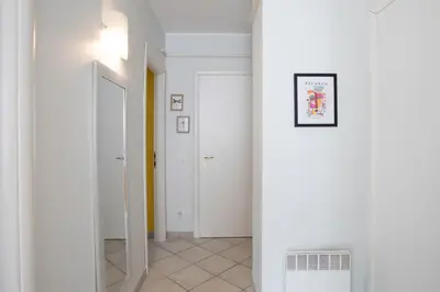 a hallway with white walls and a white column at #13 Orange suite AC Wifi Balcony 3mins walk sea front in Nice