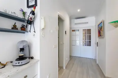 a room with a hallway with white walls and a door at PORT CARNOT AP4405 By Riviera Holiday Homes in Nice